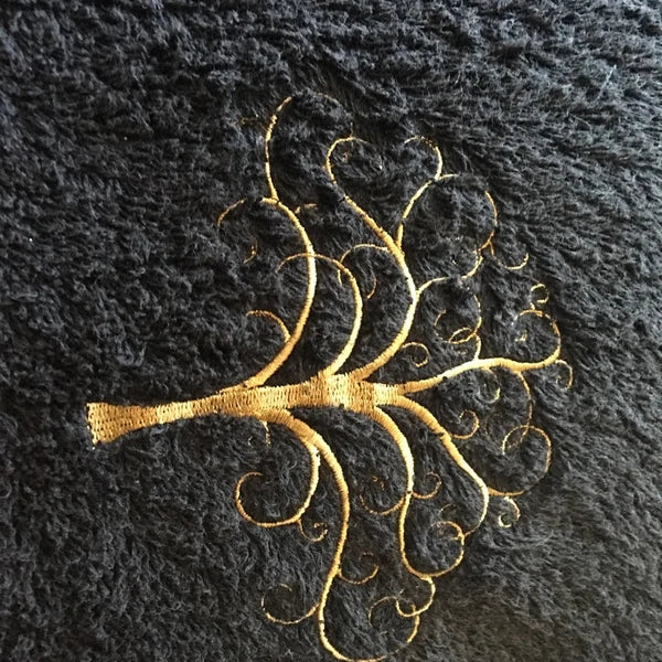 Tree Of Life Machine Embroidery stitch-out: Gold embroidered design on a black fabric background