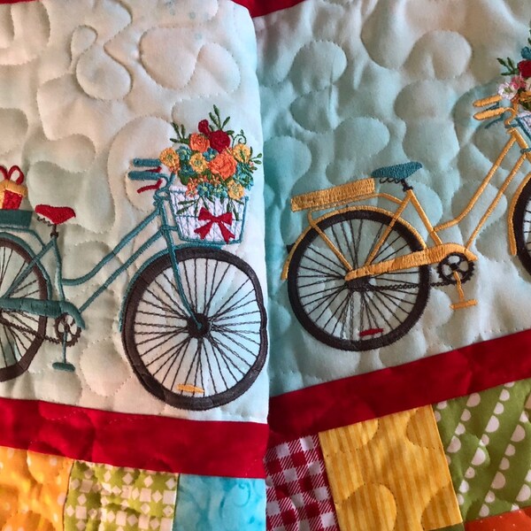 Bicycle With Flowers Machine Embroidery Design stitch-out: Quilt with embroidered bicycles and flowers on a patchwork background