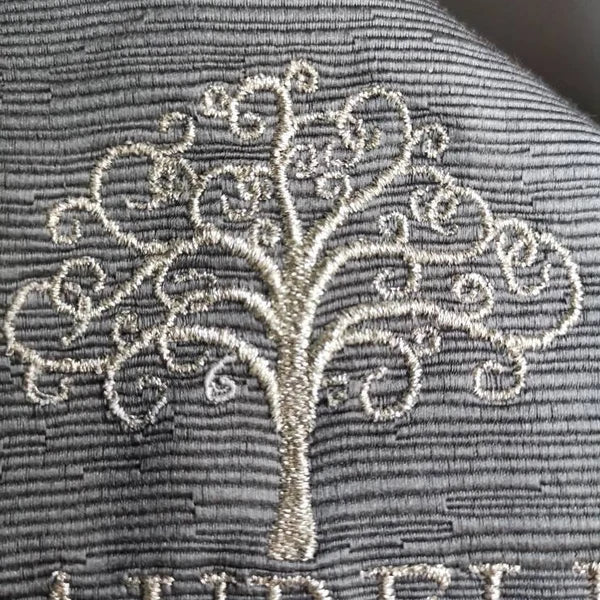 Tree Of Life Machine Embroidery stitch-out: Embroidered tree design on a textured fabric background