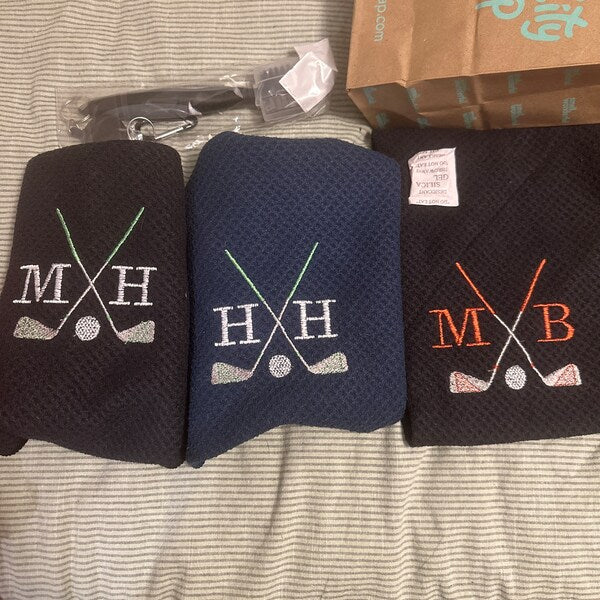 Golf Club Embroidery design stitch-out: Three black car seat covers with golf club and ball designs on a striped