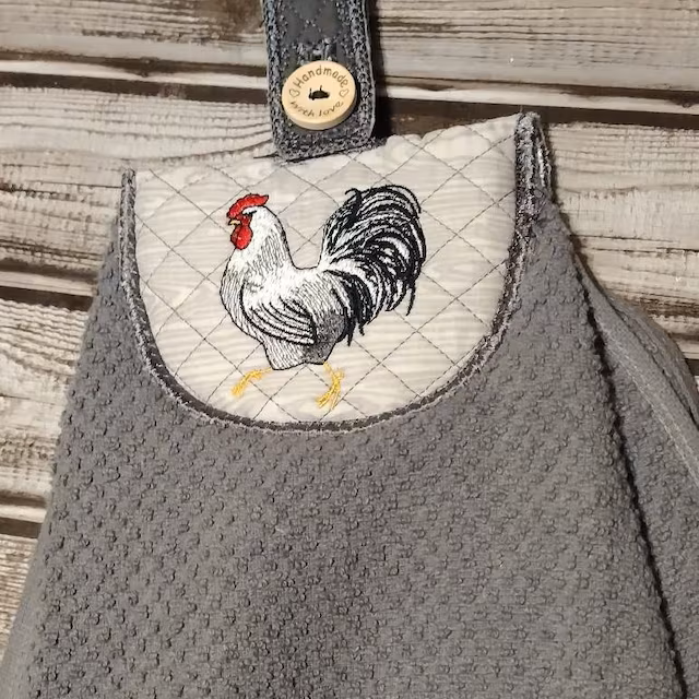 White Rooster Machine Embroidery Design stitch-out: White rooster embroidery design stitched out on an aprin