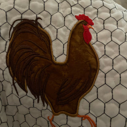 Stitch-out: Rooster Appliqué Machine Embroidery Digitized Design Pattern Embroidered onto White Quilted Fabric Featuring a Detailed Rooster Design